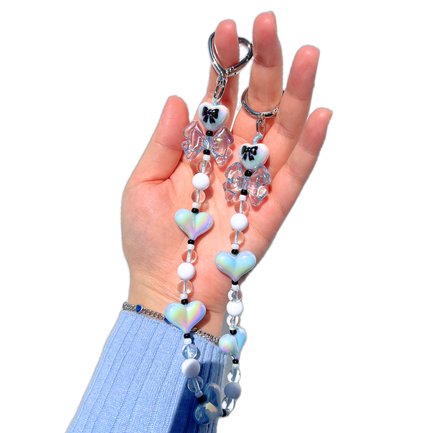 Handmade coquette style baby blue heart and bow bag charm with iridescent beads and silver hardware