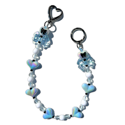 Handmade coquette style baby blue heart and bow bag charm with iridescent beads and silver hardware
